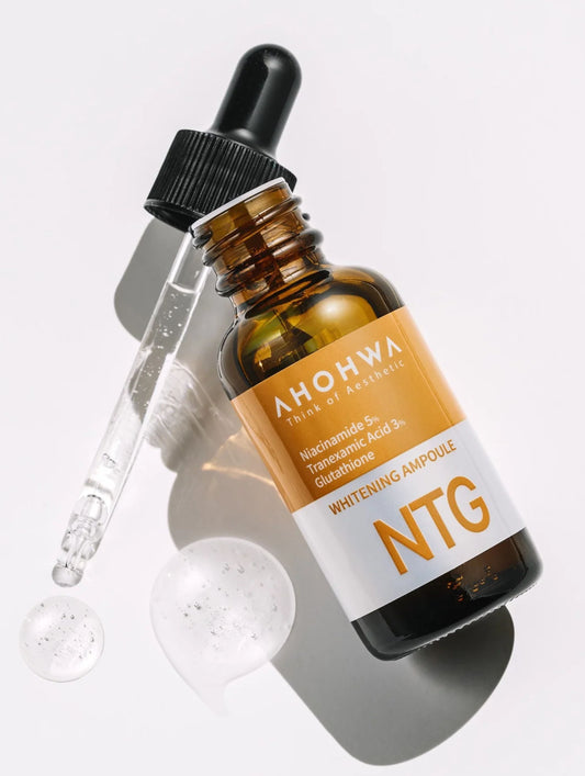 A bottle of Ahohwa NTG Whitening Ampoule with a dropper on a light gray background