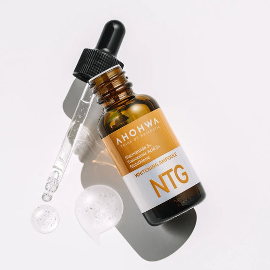 Close-up of NTG Whitening Ampoule bottle with dropper on skincare shelf